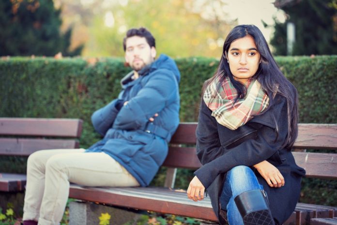 Couple after a fight sitting on bench