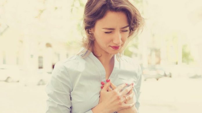 woman-holding-her-chest-with-a-possible-heart-attack-1-780x439