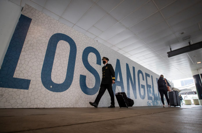 Travelers arrive for their flights at LAX as the Thanksgiving holiday getaway