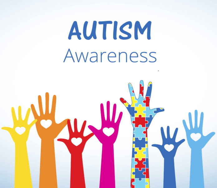 Autism awareness concept with hand of puzzle pieces