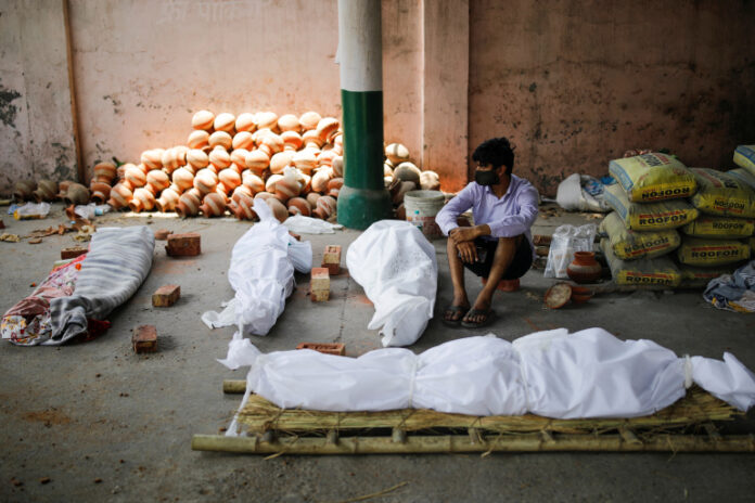 Mass cremation of those who died from COVID-19, at a crematorium in New Delhi