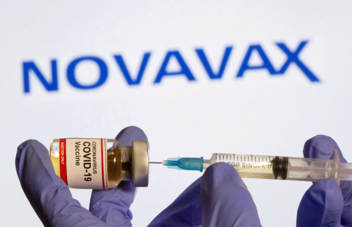 FILE PHOTO: FILE PHOTO: A woman holds a small bottle labeled with a