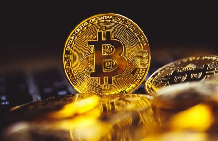 bitcoin-coins-laptop-keyboard-cryptocurrency-scaled-1-720x464